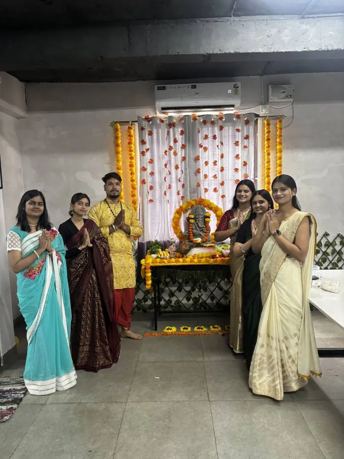 Colleagues in traditional dress at a festival puja in the office