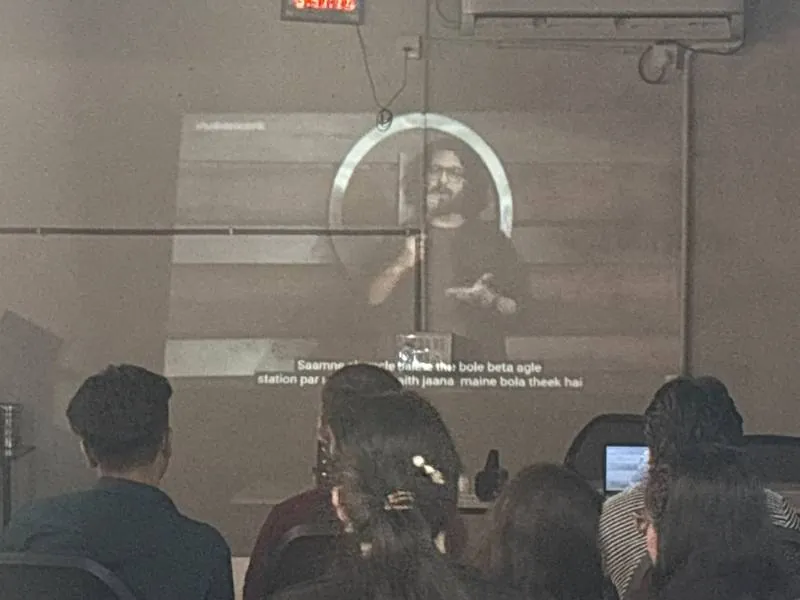 The team watching a talk on a projector