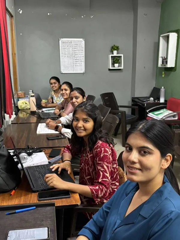Colleagues working side by side at their desks