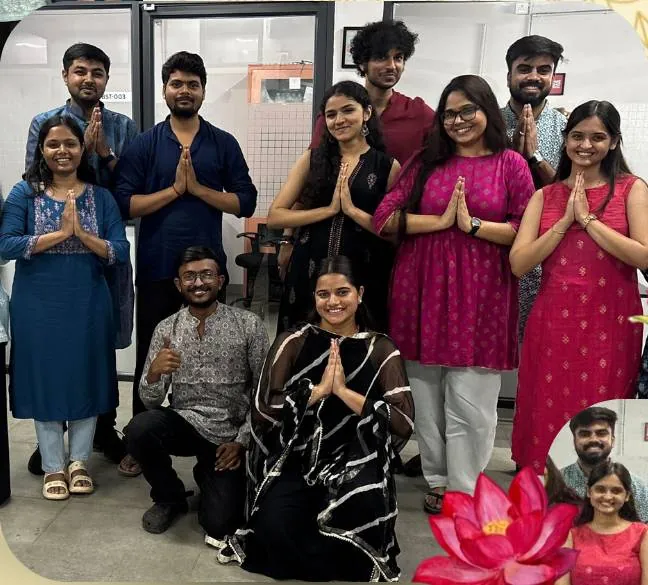 The team in traditional dress on Traditional Day, greeting with folded hands